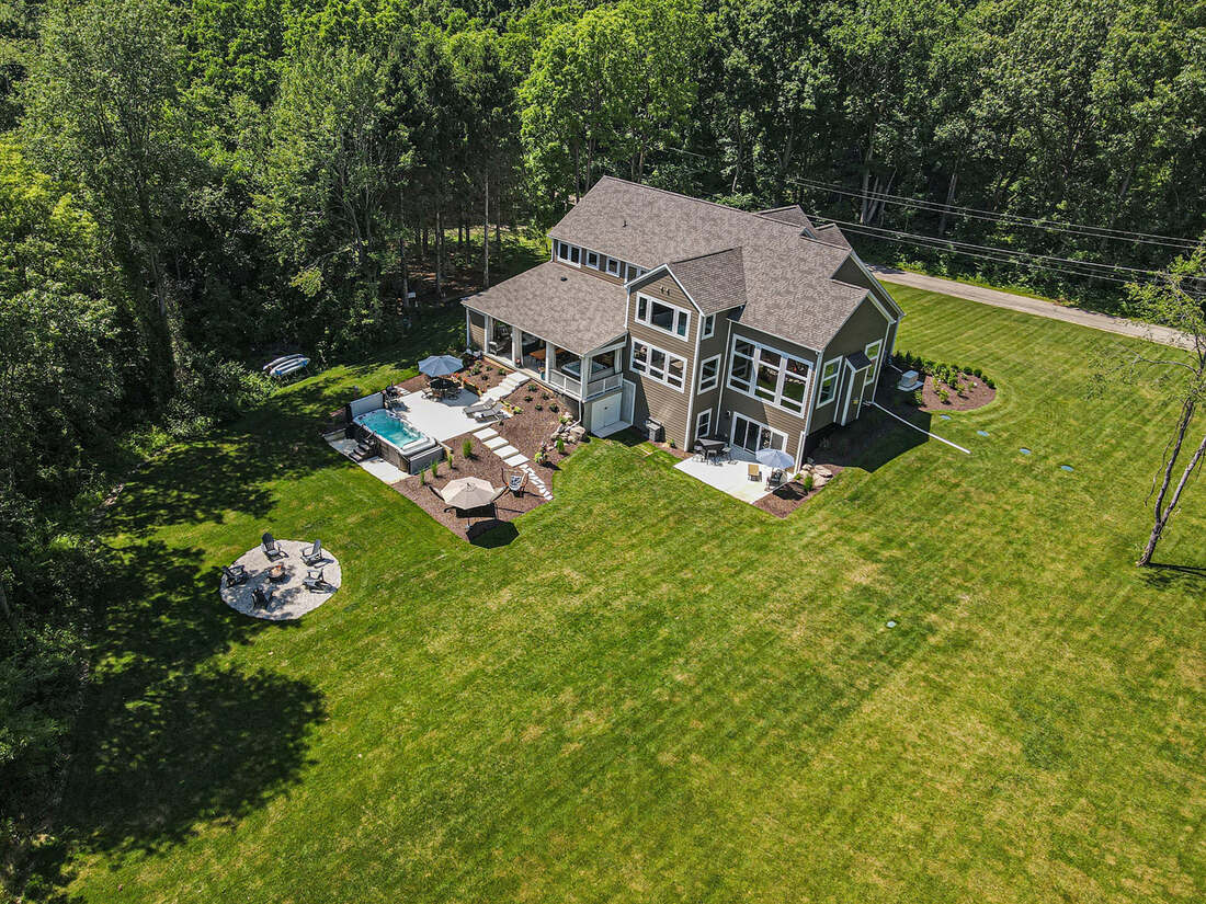 Aerial view of a completed Builder's House custom home and grounds